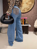 Jeans con tasca glitter maculata