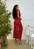 Abito con paillettes e nodo rosso
