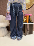 Pantalone con cravatta e risvolto
