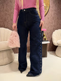 Jeans con borchie laterali