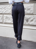 Pantalone nero con cinghie