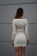 Abito in maglia beige con nodo in strass