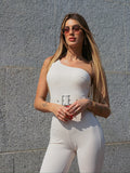 Tuta monospalla beige con cintura
