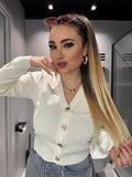 Maglioncino bianco a V con bottoni gioiello