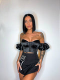 Top nero con maniche in strass