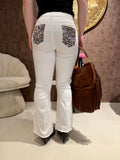 Jeans con tasca glitter maculata