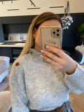 Pull grigio con bottoni gioiello