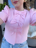 Giacca crop con fiocchi rosa
