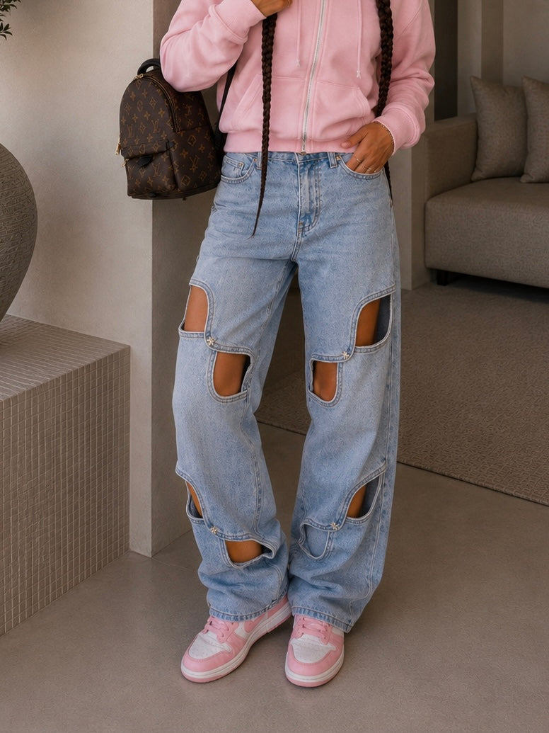 Jeans con aperture e fiocco in strass
