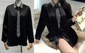Camicia nera con cravatta e strass