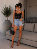 Short in jeans con cuore in strass
