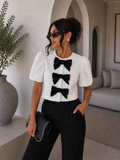 Giacca crop con fiocchi bianco nero