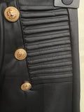 Pantalone in ecopelle con bottoni oro