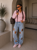 Jeans con aperture e fiocco in strass