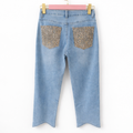 Jeans con tasca glitter maculata
