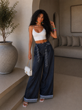 Pantalone con cravatta e risvolto