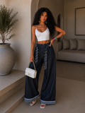 Pantalone con cravatta e risvolto