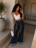 Pantalone con cravatta e risvolto