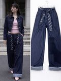 Pantalone con cravatta e risvolto