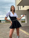 Salopette nera più camicia fiocchetto