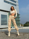 Pantalone in ecopelle con catenina beige