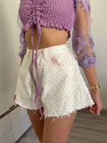 Short bianco a farfalla con strappini