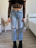 Jeans con strappi e strass