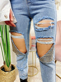 Jeans con strappi e borchie argento
