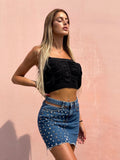Gonna di jeans con borchie e trasparenze