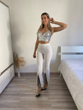 Pantaloni a zampa con strass bianco