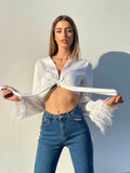 Jeans con piume bianche