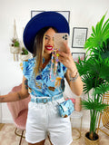 Camicia smanicata floreale con borsetta base Celeste