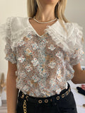 Camicia bianca a manica corta con fiori