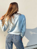 Maglione celeste con fiocchi gioiello