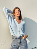 Maglione celeste con fiocchi gioiello