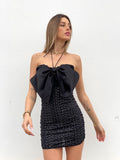 Abito con maxi fiocco e gonna in paillettes