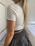 Top crop bianco con bottoncini