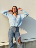 Maglione celeste con fiocchi gioiello