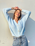 Maglione celeste con fiocchi gioiello