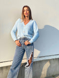Maglione celeste con fiocchi gioiello