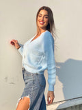 Maglione celeste con fiocchi gioiello