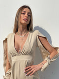 Tutina beige con fiocchetti