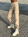 Pantalone in ecopelle con catenina beige