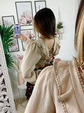 Blusa schiena aperta con lacci