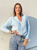 Maglione celeste con fiocchi gioiello