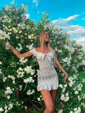Abito a pois aderente con fiocco bianco