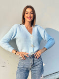 Maglione celeste con fiocchi gioiello