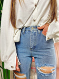 Jeans con strappi e borchie argento