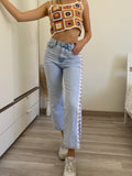 Jeans con aperture laterali