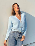 Maglione celeste con fiocchi gioiello